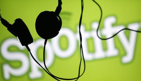 Headsets hang in front of a screen displaying a Spotify logo on it, in Zenica February 20, 2014. Online music streaming service Spotify is recruiting a U.S. financial reporting specialist, adding to speculation that the Swedish start-up is preparing for a share listing, which one banker said could value the firm at as much as $8 billion (4 billion pounds). REUTERS/Dado Ruvic (BOSNIA AND HERZEGOVINA - Tags: SCIENCE TECHNOLOGY BUSINESS SOCIETY)