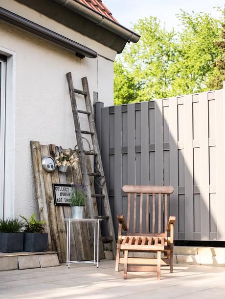 www.fim.works | Lifestyle-Blog | Terrasse mit Deckchair, Terrassendeko, WPC-Sichtschutz in Grau, altes Holz als Deko auf der Terrasse