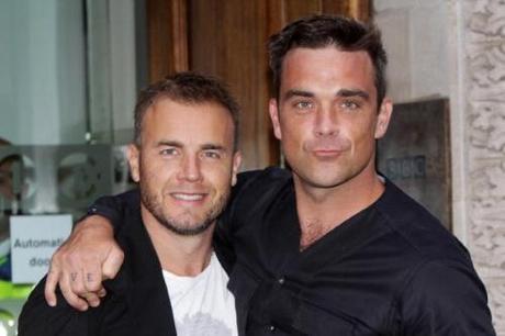 LONDON, ENGLAND - AUGUST 26: (UK TABLOID NEWSPAPERS OUT) L-R Gary Barlow and Robbie Williams pose before an interview with Chris Moyles on Radio 1 held at The Radio 1 Building on August 26, 2010 in London, England. (Photo by Dave Hogan/Getty Images)