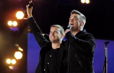 LONDON, ENGLAND - SEPTEMBER 12: Robbie Williams and Gary Barlow perform live on stage during the Heroes Concert at Twickenham Stadium, in aid of the charity Help For Heroes, on September 12, 2010 in London, England. (Photo by Jim Dyson/Getty Images)