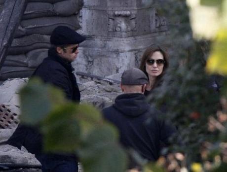 Brad Pitt (L) and Angelina Jolie are pictured in the set during the filming of her first movie Untitled Bosnian War Love Story in central Budapest October 13, 2010. Jolie will direct her first feature film about a Serbian man and Bosnian woman who meet on the eve of the 1992-95 Bosnian war. REUTERS/Bernadett Szabo (HUNGARY - Tags: ENTERTAINMENT)