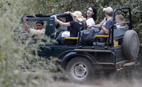 British actor Russell Brand (C) is through the Ranthambhore National Park during a jungle safari in the Sawai Madhopur district in the desert Indian state of Rajasthan October 22, 2010. U.S. singer Katy Perry and Brand are apparently due to wed at the Aman-i-Khas luxury resort in Rajasthan on October 23, local media said. REUTERS/Adnan Abidi (INDIA - Tags: ENTERTAINMENT)