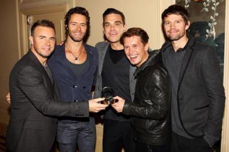 LONDON, ENGLAND - OCTOBER 25: (UK TABLOID NEWSPAPERS OUT) Gary Barlow, Howard Donald, Robbie Williams, Mark Owen and Jason Orange of Take That pose in the press room at the Q Awards 2010 held at The Grosvenor House Hotel on October 25, 2010 in London, England. (Photo by Dave Hogan/Getty Images)