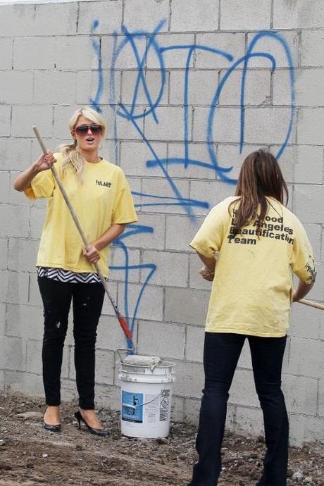 47693, LOS ANGELES, CALIFORNIA - Friday November 19, 2010. Paris Hilton, wearing a diamond Chanel necklace, arrives to do community service with the Hollywood Beautification Team. The socialite and heiress is seen trading her leather jacket and lowcut striped top for a standard yellow t-shirt featuring the organization's logo. Hilton helped other volunteers paint over graffiti found on the walls, some featuring graffiti with MS-13 markings, allegedly by the Mara Salvatrucha 13, gang. Hilton was being documented by several cameras throughout her community service work, and also never changed out of her off her black stiletto heels. She was seen several hours later signing a document that reportedly confirmed her community service hours. Before leaving, Hilton was assisted with putting on a band-aid on her finger. The heiress looked to be in good spirits after her day's work, not seeming to care that she had paint stains on her pants and heels! Photograph: Sam Sharma / Nate Jones,  PacificCoastNews.com