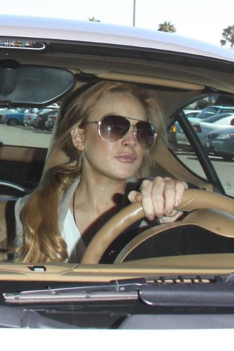 44906, LOS ANGELES, CALIFORNIA - Tuesday September 14, 2010. A smiling Lindsay Lohan and her assistant Eleonore leave the Santa Monica courthouse and drive off in a white Porsche. Photograph:  David Tonnessen, PacificCoastNews.com