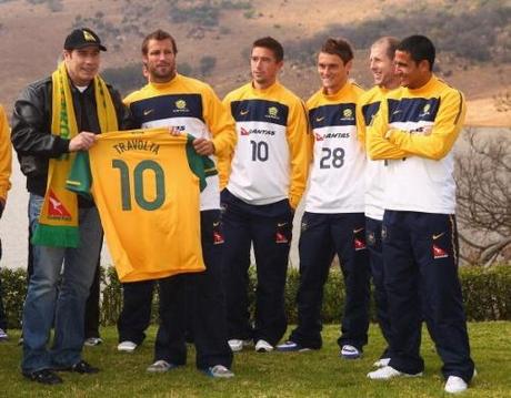 MULDERSDRIFT, SOUTH AFRICA - JUNE 11: John Travolta, Qantas Goodwill Ambassador is handed a Socceroo shirt by Australian captain Lucas Neill as the Socceroos prepare ahead of the 2010 FIFA World Cup, at Kloofzicht Lodge on June 11, 2010 in Muldersdrift, South Africa. (Photo by Robert Cianflone/Getty Images)