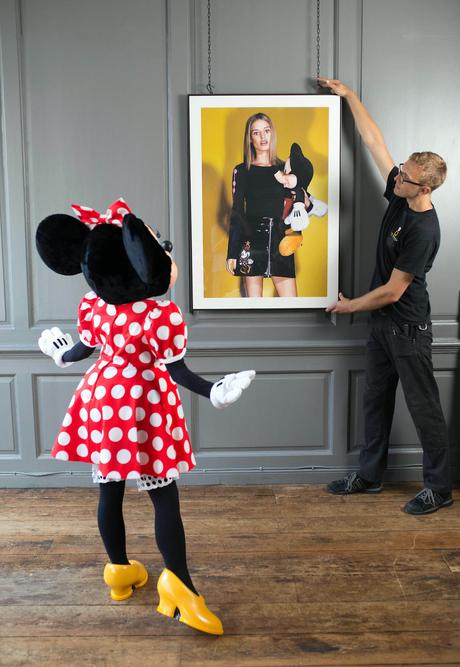 EDITORIAL USE ONLY Minnie Mouse watches as artwork is hung at Blacks Club in London, ahead of the opening of new exhibition, Minnie: Style Icon, in partnership with the British Fashion Council, which will be on display at the Soho venue during London Fashion Week. PRESS ASSOCIATION Photo. Picture date: Thursday September 17, 2015. The exhibition of exclusive photographs, exploring the character of Disney's Minnie Mouse and her influence on fashion and pop culture, has been curated with the help of model and photographer, Georgia May Jagger. Photo credit should read: David Parry/PA Wire