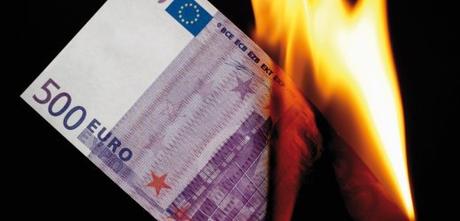 500 euro note burning against black background --- Image by © Dieter Heinemann/Westend61/Corbis