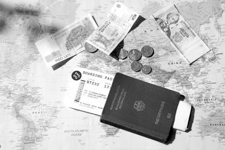 Reisepass, Bordkarte und Geld aus verschiedenen Ländern liegt auf einer Weltkarte, Foto: Robert B. Fishman, ecomedia, 16.9.2012