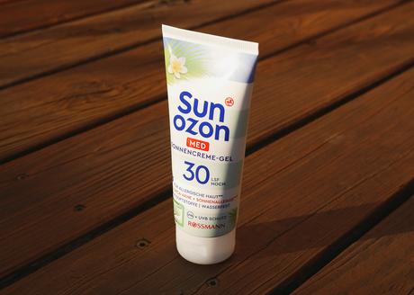 Sun Ozon Med Sonnencreme-Gel auf Holzgrund