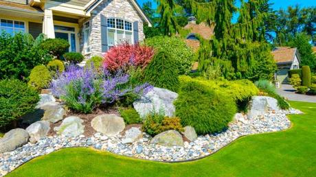 Vorgarten mit Steinen und grünen Pflanzen