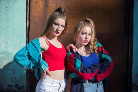 Lässig und grell: Ladys im bauchfreien Top und Neonfarben verkörpern den typischen 90er-Style.
