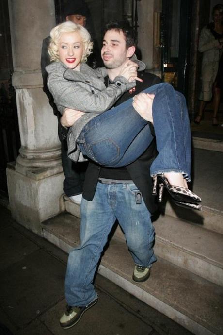 46081, LONDON, UNITED KINGDOM - Wednesday October 13 2010. FILE PICTURE DATED March 8 2006. Christina Aguilera and Jordan Bratman pictured in happier days. The couple announced this week that they are to divorce after nearly five years of marriage. The popstar wed her music producer husband in Nov 2005 and the pair are parents to 2-year-old son Max. A source tells UsMagazine.com the couple have been separated for a few months . The insider adds, They are now living apart, and they will see how that goes. They are very much in love. But over the last six months, it became clear they were more like friends than husband and wife. Aguilera's marriage breakdown is the latest in a spate of celebrity splits. PICTURE CAPTION: Jordan carries his wife Christina out of their London hotel.  Photograph:  Smart Pictures, PacificCoastNews.com
