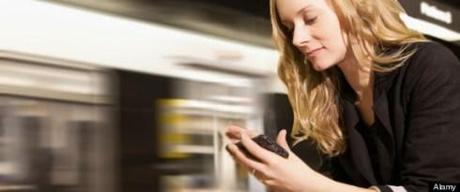 USA, California, Los Angeles, Woman sending text messages on subway station. Image shot 2012. Exact date unknown.