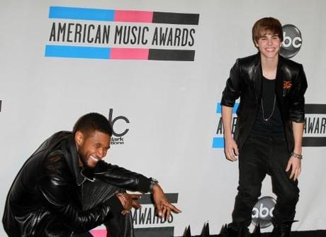 Singers Justin Bieber and Usher pose with their awards together in the press room at the 38th Annual American Music Awards in Los Angeles, California on November 21, 2010. Usher took home two and Bieber with four.  Fame Pictures, Inc