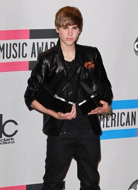 Singer Justin Bieber pose with his awards for T-Mobile's Breakthrough Artist , Pop/Rock Favorite Male Artist and Artist Of The Year in the press room at the 38th Annual American Music Awards in Los Angeles, California on November 21, 2010.  Fame Pictures, Inc