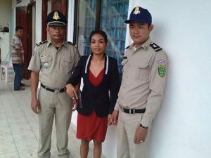 Junge Khmer Frau zwischen zwei Polizisten