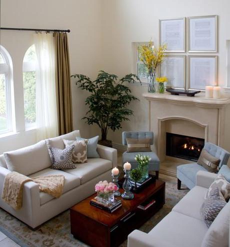 Two white sofas and a wooden coffee table in front of a fireplace
