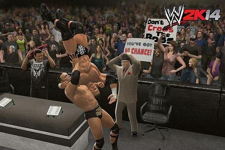 The Rock schmettert Triple H durch das Kommentatorenpult.