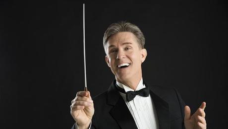 Male Orchestra Conductor Looking Away While Directing